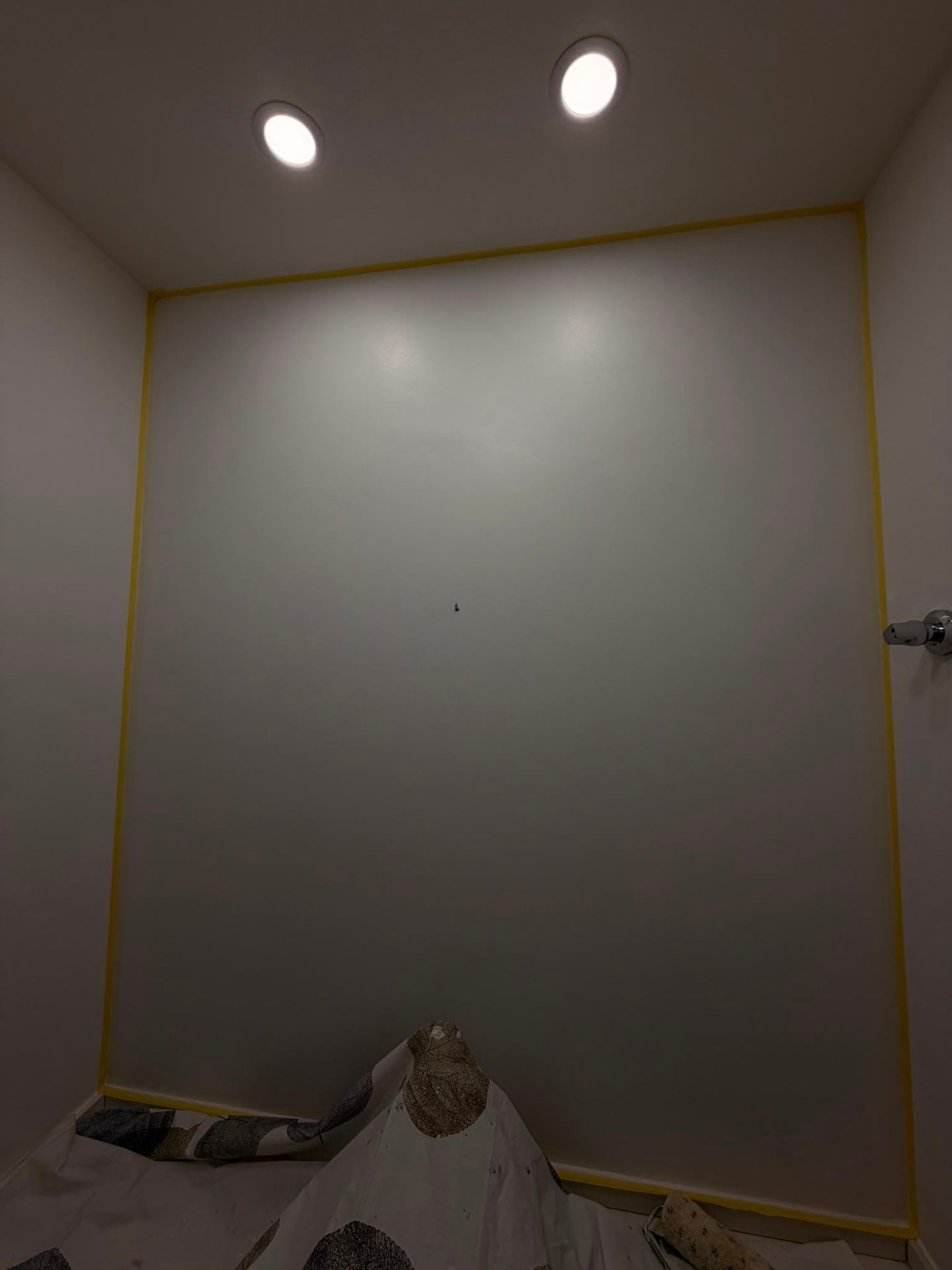 Bathroom wall prepared and protected before painting