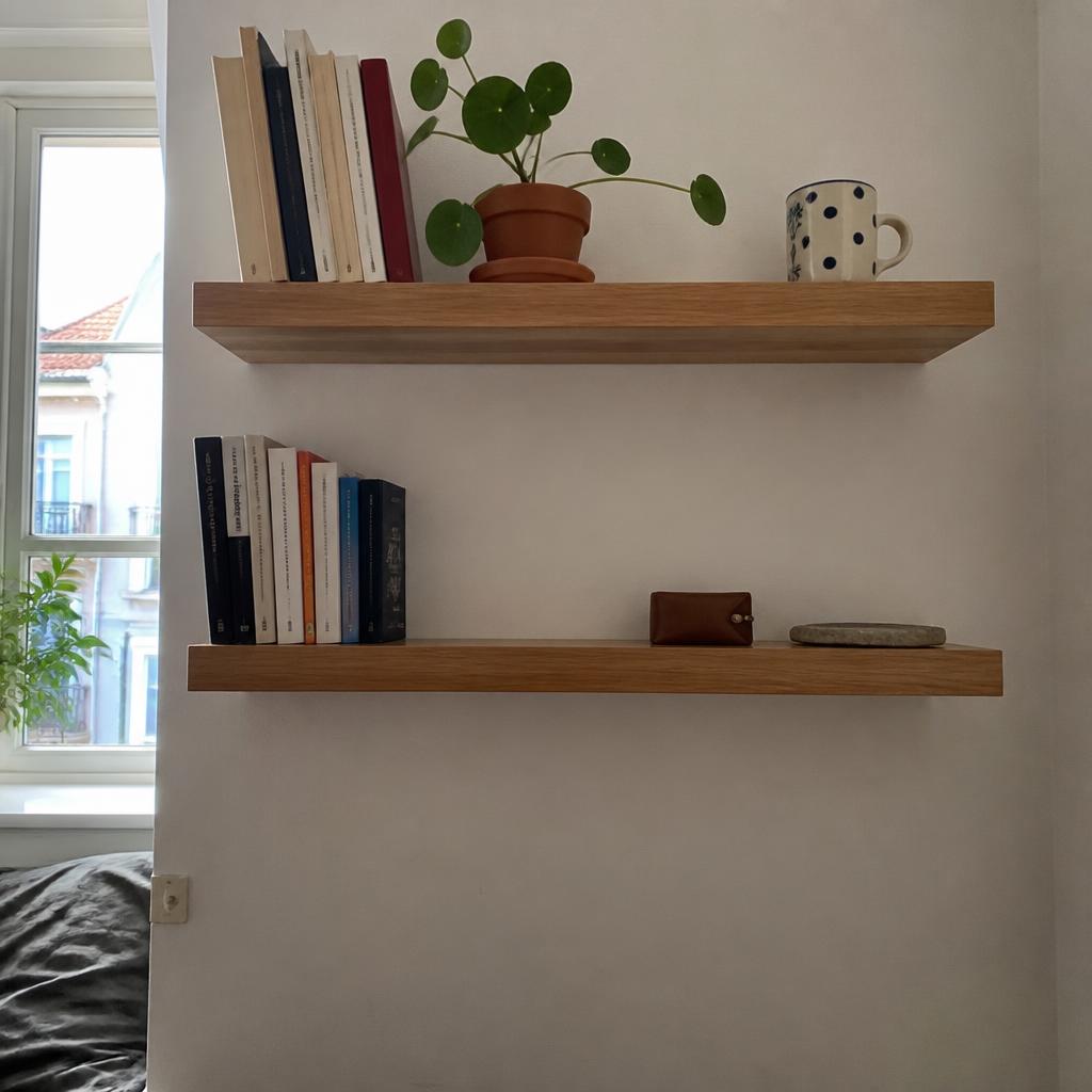Two floating wooden shelves perfectly level on a white wall